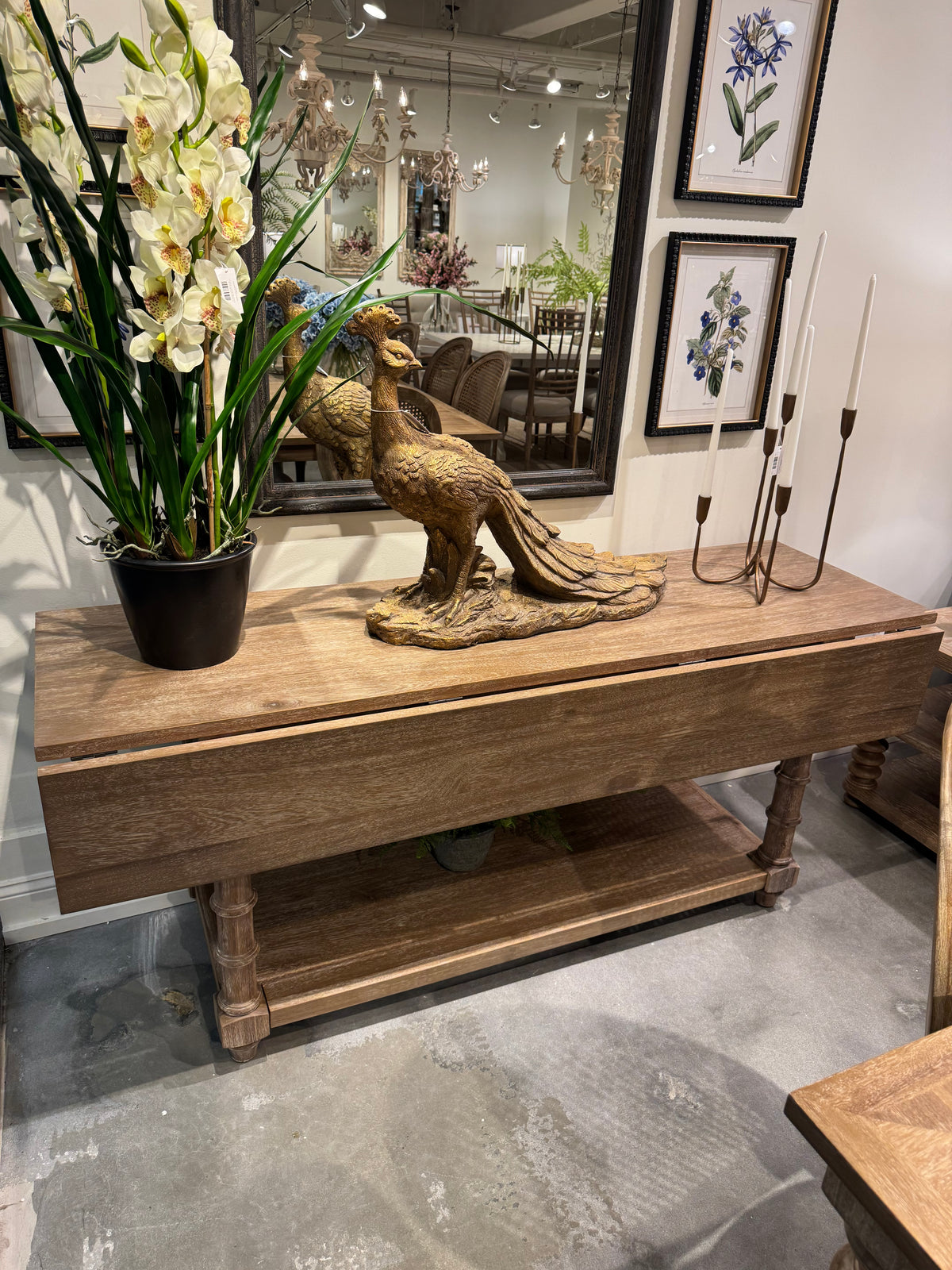 Decorative elements including a wooden sculpture, flowers, and framed pictures in an indoor setting, Modern Farmhouse Furniture for sale