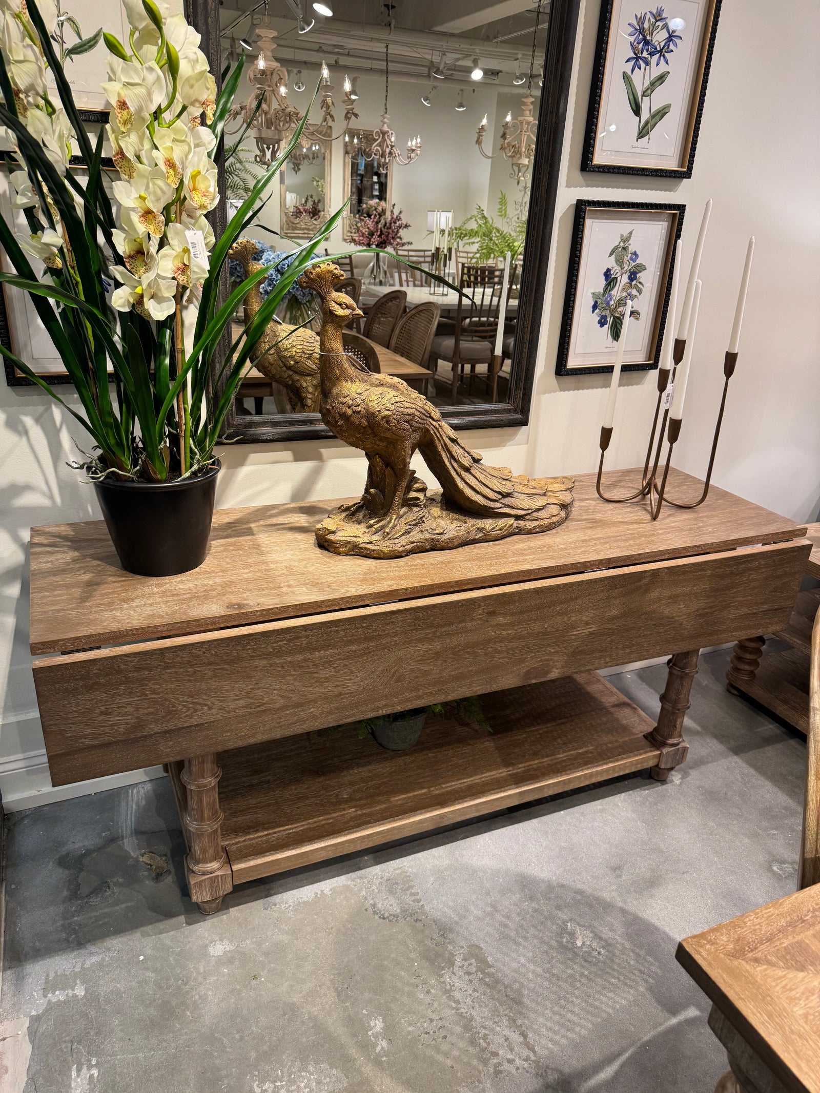 Decorative elements including a wooden sculpture, flowers, and framed pictures in an indoor setting, Modern Farmhouse Furniture for sale