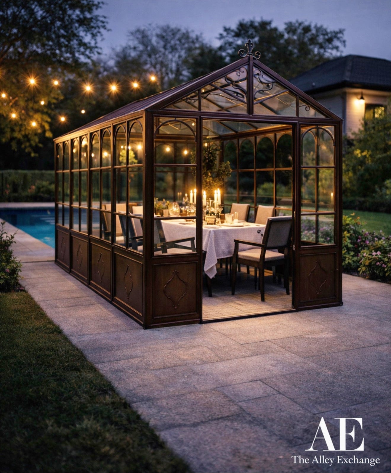 Glasshouse with outdoor seating area at dusk, illuminated by string lights.